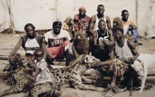 African beastmasters! | They are like a guild of beastmasters. Everyone has something that bites. Maybe the circus is in town, or they just really like dangerous animals.
