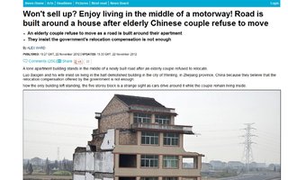 Kiinalainen pariskunta kieltäytyy muuttamasta muualle - talon ympärille rakennettiin moottoritie